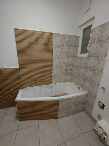 Sarokkádas fürdőszoba fahatású csempeburkolattal